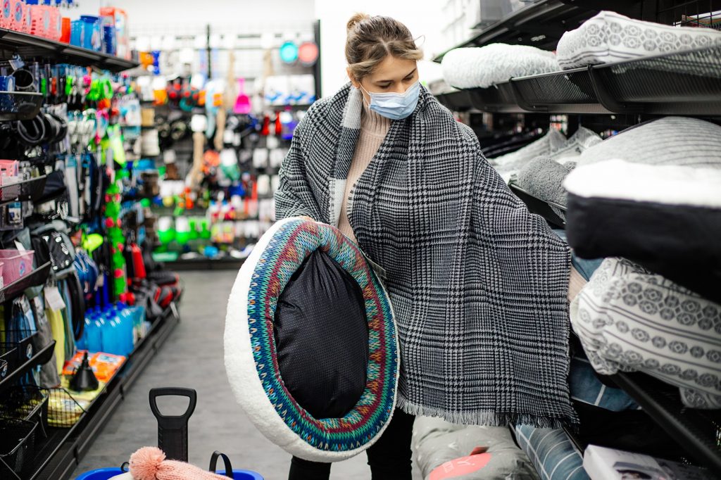 Woman choosing dog cat bed for pet, gift for mammal, shopping mall, pet shop department